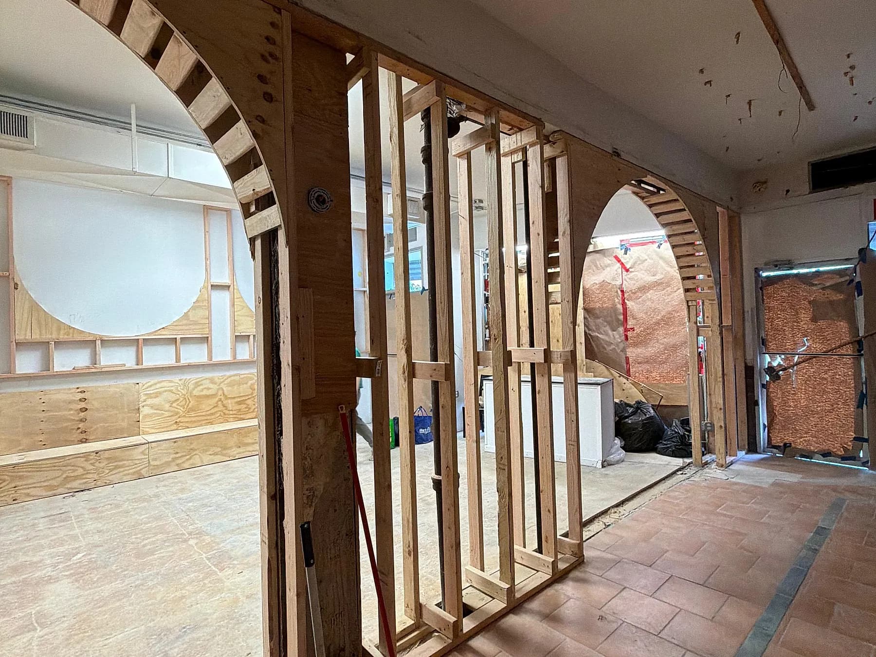 A dining room set out in arched timber partitions before boarding