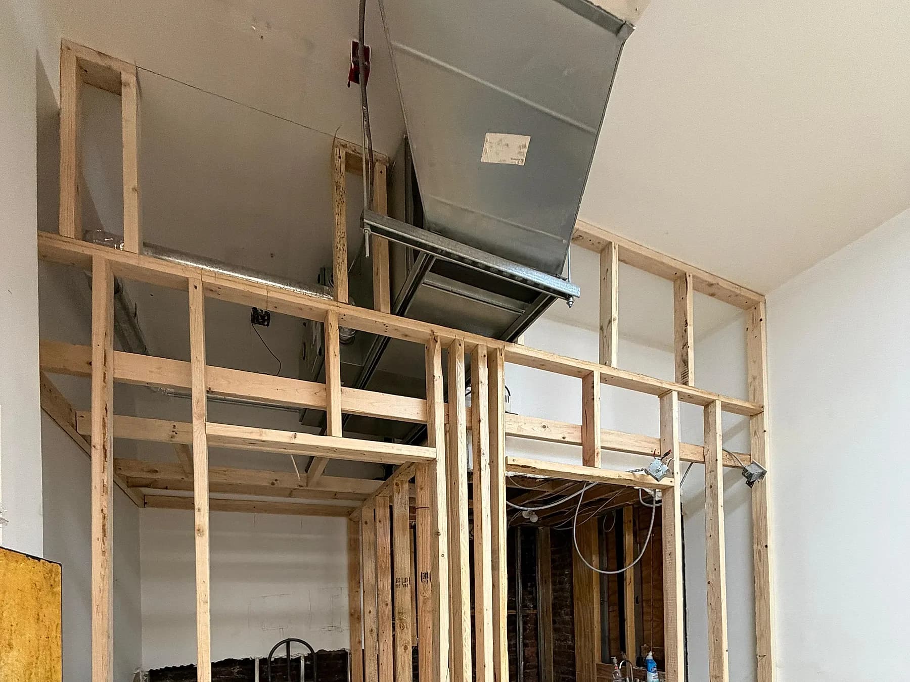 Timber stud partitions framed around new ductwork and electrical rough-in