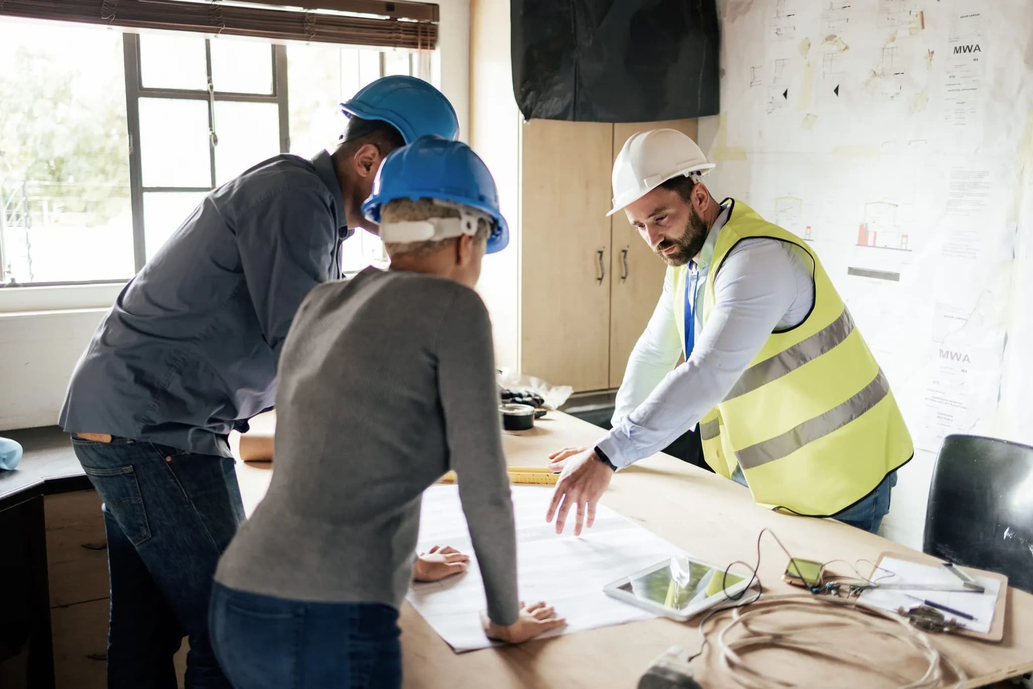 A team reviewing architectural drawings together over a table